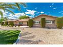 Attractive single-story home showcasing desert landscaping, mature shrubs, and a manicured lawn at 9660 W Ann Rd, Las Vegas, NV 89149