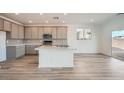 Modern kitchen with white countertops, stainless steel appliances, shaker cabinets, and hardwood floors at 9842 Lost Horse Ave, Las Vegas, NV 89178