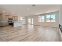 Open living space features a modern kitchen, dining area and hardwood floors, great for entertaining at 9842 Lost Horse Ave, Las Vegas, NV 89178