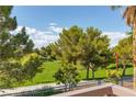 Scenic view of a lush green lawn with mature trees, creating a tranquil and inviting outdoor space at 1551 Boundary Peak Way, Las Vegas, NV 89135