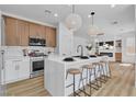 Modern kitchen with an island, stylish pendant lighting, stainless steel appliances, and sleek countertops at 1551 Boundary Peak Way, Las Vegas, NV 89135