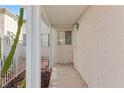 Inviting entryway featuring a covered porch, textured walls, and a secure front door with a security gate at 2152 High Dunes Ln, Laughlin, NV 89029