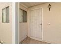 Close-up of front door showing the security gate with decorative design, the front door, and a light fixture at 2152 High Dunes Ln, Laughlin, NV 89029