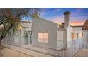 Charming single-Gathering home featuring a cozy front yard with secure white picket fence and desert landscaping at 2152 High Dunes Ln, Laughlin, NV 89029