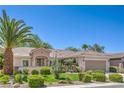 Landscaped single-story home featuring a tiled roof, desert plants, and a paved driveway at 2225 Blackburn Hills Ave, Henderson, NV 89044