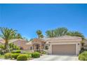 Attractive single-story home featuring a manicured front yard with desert landscaping and attached garage at 2225 Blackburn Hills Ave, Henderson, NV 89044