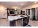 Contemporary kitchen with a large island, stainless steel appliances, and seamless access to the living area at 226 Callen Falls Ave # 1311, Henderson, NV 89011