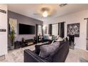 Modern living room featuring stylish decor, large TV, comfortable seating, and contemporary tile flooring at 226 Callen Falls Ave # 1311, Henderson, NV 89011