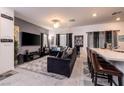 Open-concept living room with sleek furniture, large TV, and a breakfast bar for casual dining at 226 Callen Falls Ave # 1311, Henderson, NV 89011