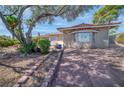 Inviting single-story home with mature landscaping and a cozy front yard at 2880 Placita Ct, Las Vegas, NV 89121