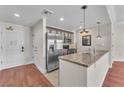 Modern kitchen featuring stainless steel appliances and a breakfast bar with granite countertops at 30 Strada Di Villaggio # 441, Henderson, NV 89011