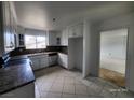Well-lit kitchen with white cabinets, granite countertops, tile flooring, and stainless steel appliances at 3112 Piedmont Ave, Las Vegas, NV 89102