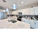 Bright kitchen with stainless steel appliances and white cabinets at 3114 Molinos Dr, Las Vegas, NV 89141