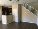 Open-concept living room with tile flooring and stairway access at 3175 Obscured Light Walk, Henderson, NV 89044