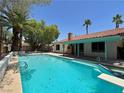 Relaxing backyard pool with mature landscaping and a covered patio area to enjoy the weather at 349 Esquina Dr, Henderson, NV 89014