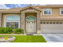 Elegant entryway with double doors, stone pillars, and manicured landscaping at 3692 River Canyon Rd, Las Vegas, NV 89129