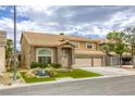 Charming two-story home with a three-car garage and well-maintained front yard at 3692 River Canyon Rd, Las Vegas, NV 89129