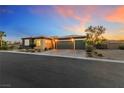 Beautiful single-story home with desert landscaping and a two-car garage at sunset at 4317 Velvet Ridge Ct, Las Vegas, NV 89129