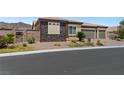 Attractive single-story home with rock landscaping and a two-car garage on a sunny day at 4317 Velvet Ridge Ct, Las Vegas, NV 89129