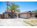 View of a single story brick home with a 2 car garage at 4516 E Flamingo Rd, Las Vegas, NV 89121
