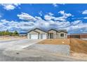 Inviting single-story home with a three-car garage, desert landscaping, and a welcoming entrance at 4801 Stoneham, Pahrump, NV 89061