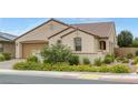 Single-Gathering home with a barrel tile roof, desert landscaping, and a two-car garage at 489 Intonation St, Henderson, NV 89011