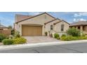 Single-Gathering home featuring desert landscaping, a barrel tile roof, and attached two-car garage at 489 Intonation St, Henderson, NV 89011