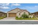 Charming single-story home with a well-manicured lawn, inviting curb appeal, and a two-car garage at 489 Intonation St, Henderson, NV 89011
