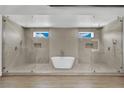 Luxurious bathroom featuring a soaking tub centered between dual walk-in showers with glass enclosures at 5015 Thunder River Cir, Las Vegas, NV 89148
