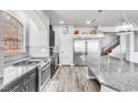 Kitchen with stainless steel appliances, granite countertops, and a view of the staircase at 5976 Rockway Glen Ave, Las Vegas, NV 89141
