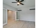 Bedroom featuring wood-look flooring, gray walls, and a door leading to another room at 6085 Ryan Ranch Ave, Las Vegas, NV 89130