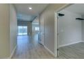 Bright entryway with wood-look flooring and an open floor plan leading to the living area at 6085 Ryan Ranch Ave, Las Vegas, NV 89130