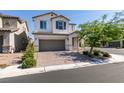 Charming two-story home with a well-manicured front yard and a brick-paved driveway at 6442 Kobe Knoll Ct, Las Vegas, NV 89141
