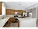 This kitchen features an island, stainless appliances and wooden cabinetry at 6591 Gertrude Ct, Las Vegas, NV 89141