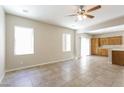 Bright living room features tile flooring, ceiling fan, and view into kitchen at 6591 Gertrude Ct, Las Vegas, NV 89141