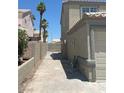 Long driveway leading to backyard with gate and concrete block walls at 8068 Cetus Cir, Las Vegas, NV 89128