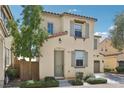 Charming two-story home featuring a tile roof, tan siding, and manicured landscaping at 8341 Lower Trailhead Ave, Las Vegas, NV 89113