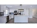 Modern kitchen featuring white cabinets, an island, stainless steel appliances, and a stylish backsplash at 836 Cherry Dr, Henderson, NV 89002