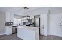 Well-designed kitchen with white cabinets, quartz countertops, an island, and modern lighting fixtures at 836 Cherry Dr, Henderson, NV 89002