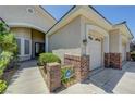 Beautiful home exterior featuring brick accents, lush landscaping, and a security system at 905 Star Pine Dr, Las Vegas, NV 89144