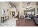 Spacious living area with a staircase, hardwood floors, and decorative columns at 9660 Drayton Ave, Las Vegas, NV 89148