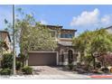 Charming home with neutral tones, an attached two-car garage, mature trees, a well-manicured yard and a tiled roof at 9950 Coyote Echo Ct, Las Vegas, NV 89166