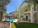 Lush backyard featuring a pool, patio, and upper balcony with a view at 10 Gulf Pines Ave, Las Vegas, NV 89148