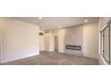 Spacious living room with electric fireplace and large windows at 10421 Linfield Pl, Las Vegas, NV 89134