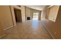 The spacious living room features tile flooring, a fireplace and access to the backyard at 1081 Overture Dr, Las Vegas, NV 89123