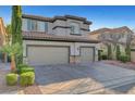 Charming two-story home featuring a three car garage, neutral stucco exterior and well maintained landscaping at 11417 Rock Cove Way, Las Vegas, NV 89141