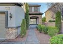 Charming stucco home with stone accents, front yard desert landscaping and covered front entrance at 11417 Rock Cove Way, Las Vegas, NV 89141