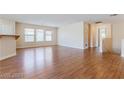 Spacious living room with wood flooring and natural light at 11577 Vesuvio Ct, Las Vegas, NV 89183