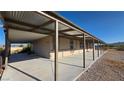 Single-story home with long covered patio and desert landscaping on a bright day at 1180 Lava Ave, Jean, NV 89019