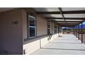 Exterior facade featuring a long covered patio, windows, and a beautiful desert landscape at 1180 Lava Ave, Jean, NV 89019